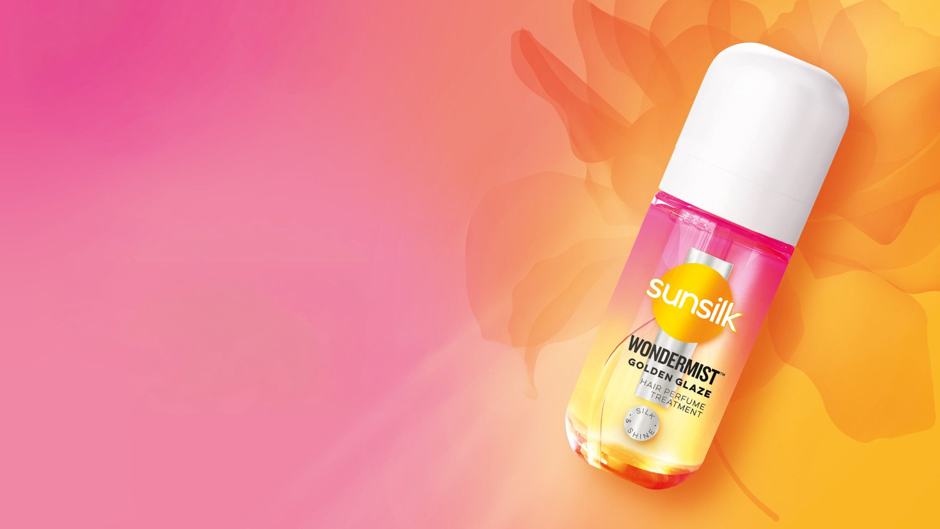 สเปรย์ฉีดผมวันเดอร์มิสท์โฉมใหม่จากซันซิลมาในสี Golden Glaze ขวดสเปรย์ขนาดเล็กสีชมพูและสีส้มบนพื้นหลังสีชมพูและสีส้ม
