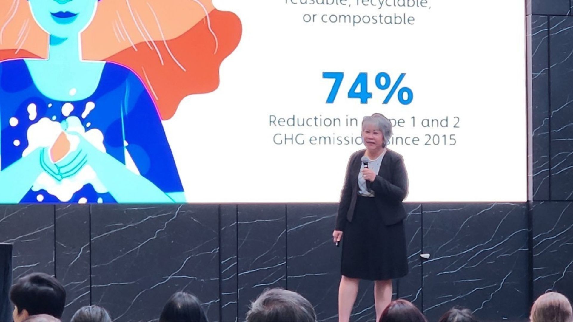 Ms Chu Lim speaking on stage